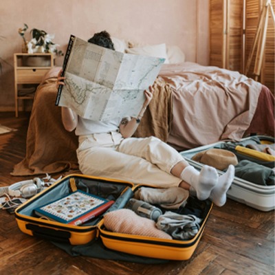 women sitting reading a map and packing